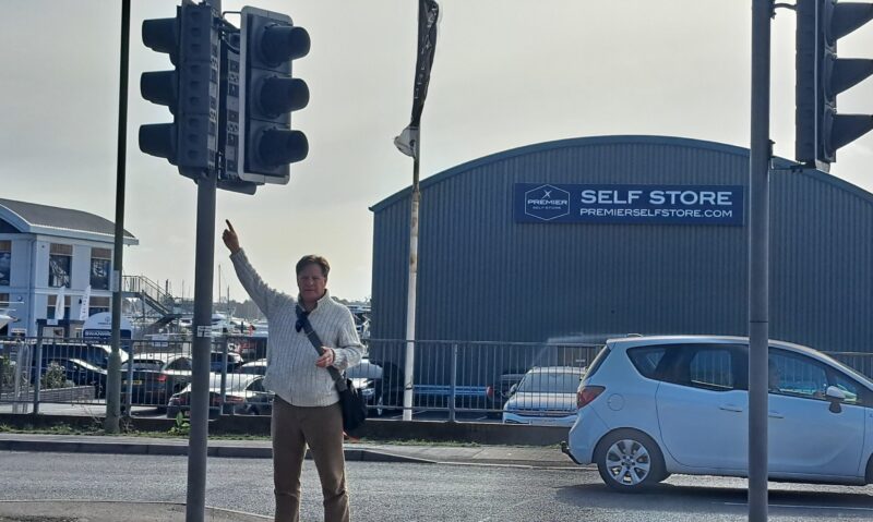 Picture of community champion pointing at traffic signals